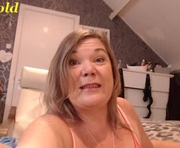 amigold is a 56 year old female webcam sex model.